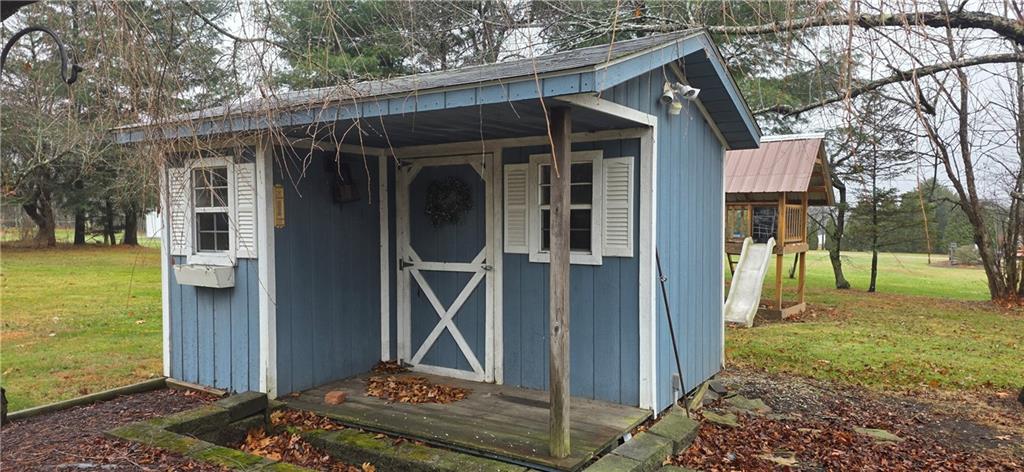 175 Blackfield Road Garrett, PA 15542 - Photo 32 of 37 a view of a wooden house with a big yard and large trees
