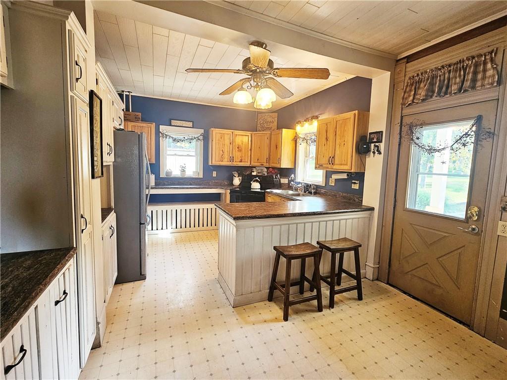 175 Blackfield Road Garrett, PA 15542 - Photo 4 of 37 a kitchen with a table chairs refrigerator and cabinets