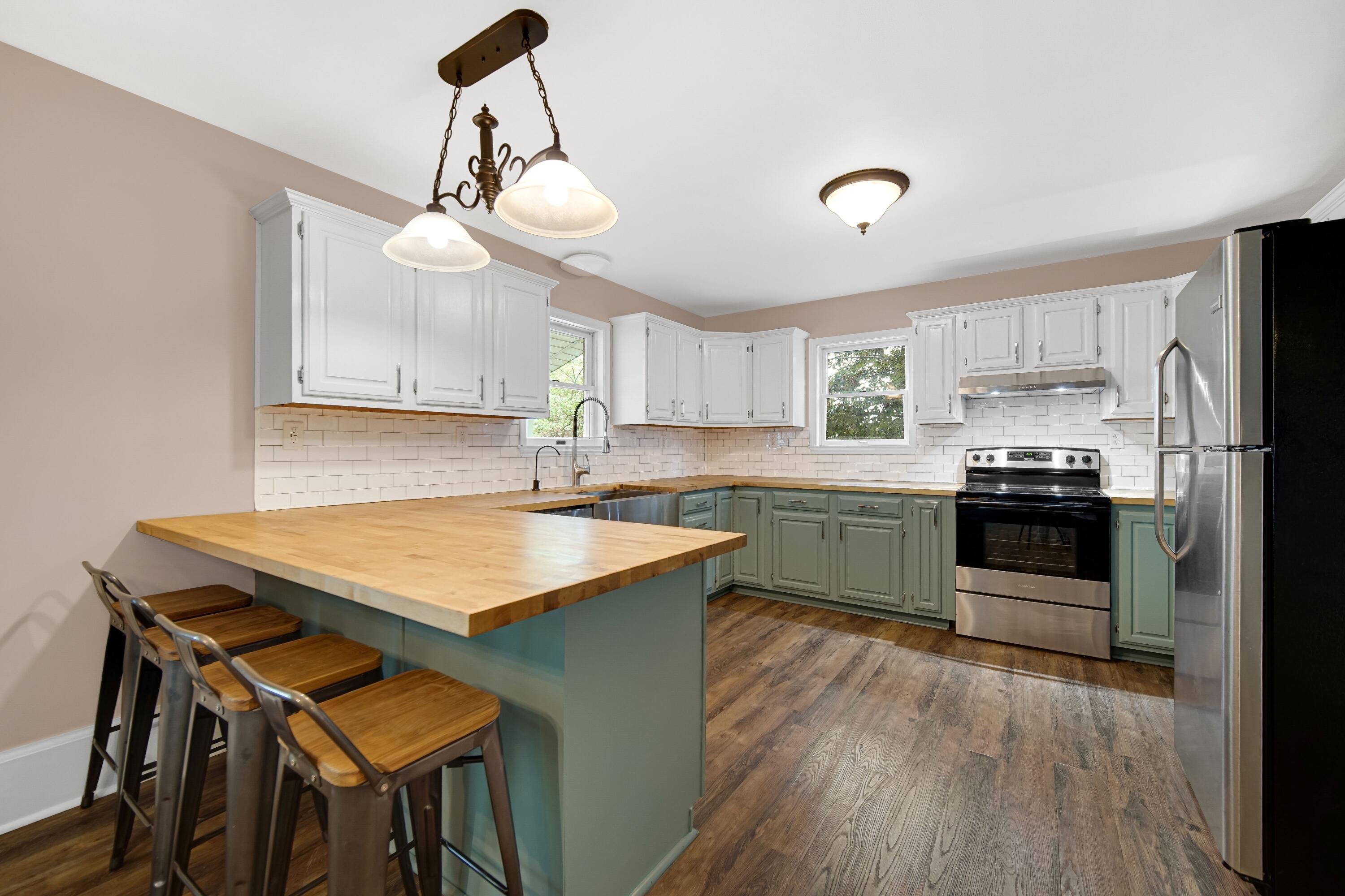 476 Highway 2 Hebron, IN 46341 - Photo 8 of 25 a kitchen with a stove a sink and a refrigerator