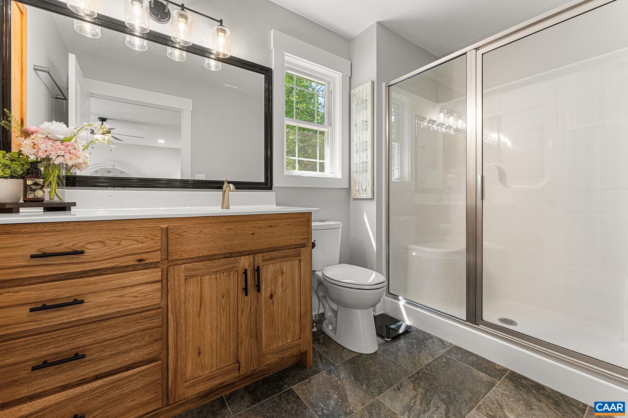 230 Fox Hollow Road Ruckersville, VA 22968 - Photo 26 of 42 a bathroom with a granite countertop sink toilet and shower