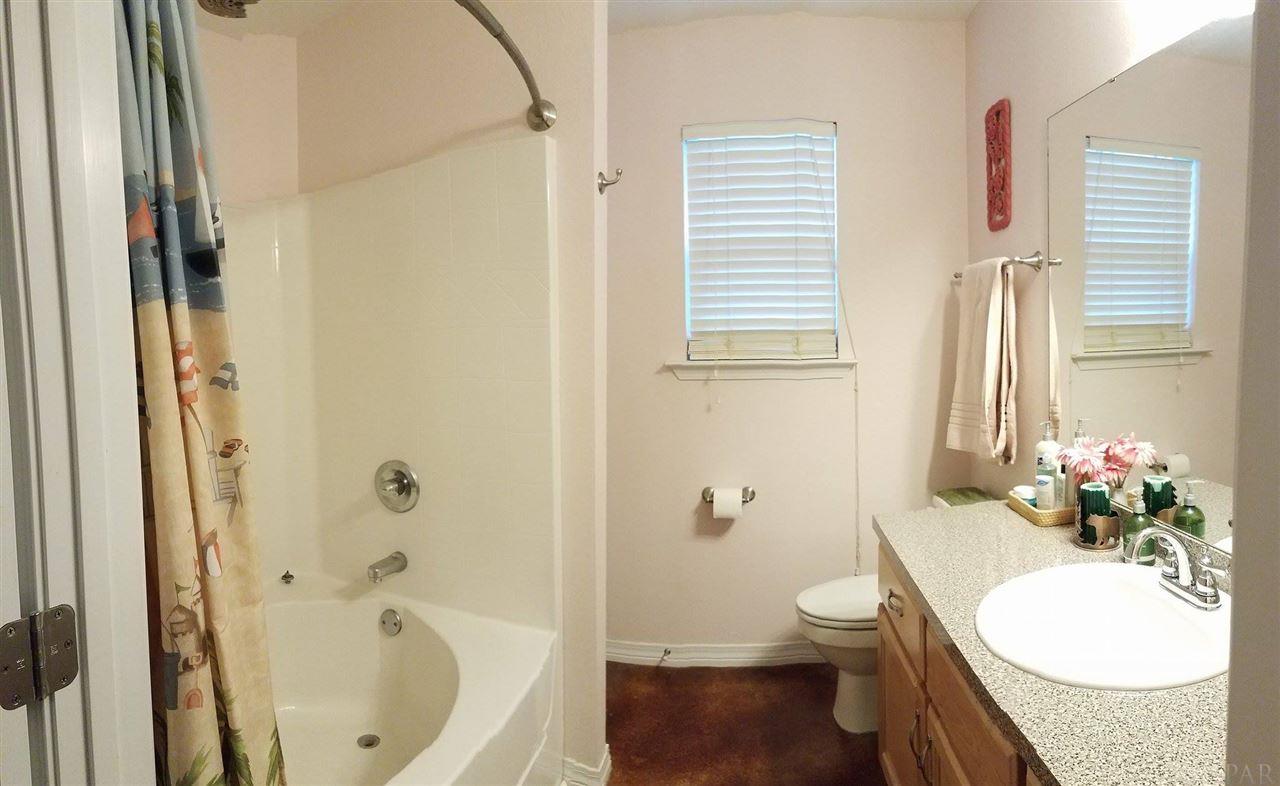 4708 Old Guernsey Road Pace, FL 32571 - Photo 25 of 46 a bathroom with a granite countertop sink toilet and shower