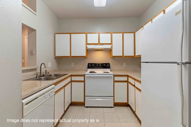 a kitchen with a stove and a refrigerator