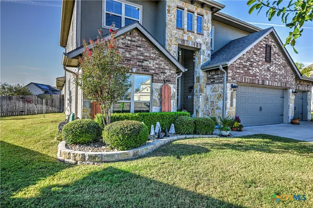 a view of a house with backyard and porch