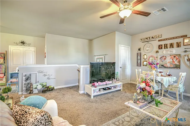 a living room with furniture and flowers
