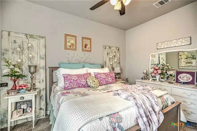 a bedroom with bed and a chandelier
