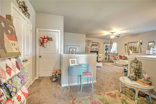 a living room with furniture and painting on the wall