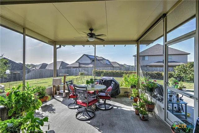a view of a patio with a table and chairs under an umbrella