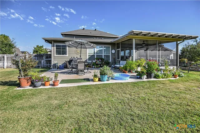 a view of a house with swimming pool and sitting area