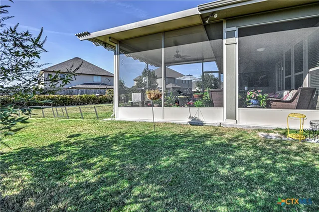 a view of a house with a backyard and a garden