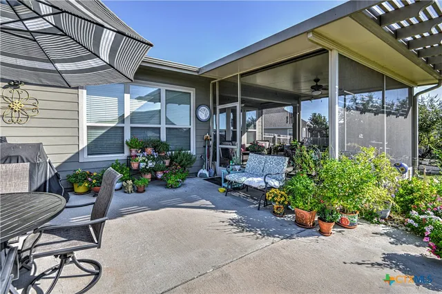 a view of a chairs and table in patio
