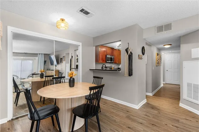 a view of a dining room with furniture and wooden floor