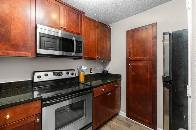 a kitchen with a refrigerator and cabinets