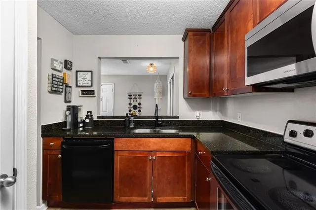 a kitchen with a stove microwave and sink