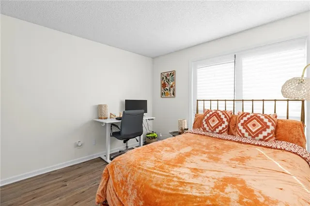 a bedroom with a bed and a desk