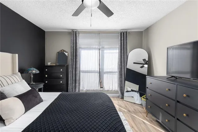 a bedroom with a large bed and a chandelier