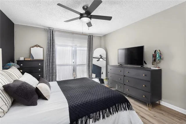 a bedroom with a bed and a lamp on table