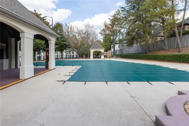 a view of a patio with couches and table under an umbrella