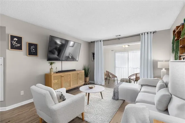 a living room with furniture and a lamp