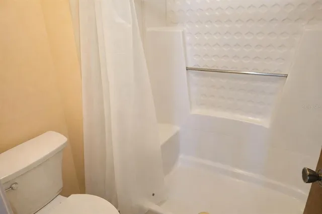 a bathroom with a shower and toilet