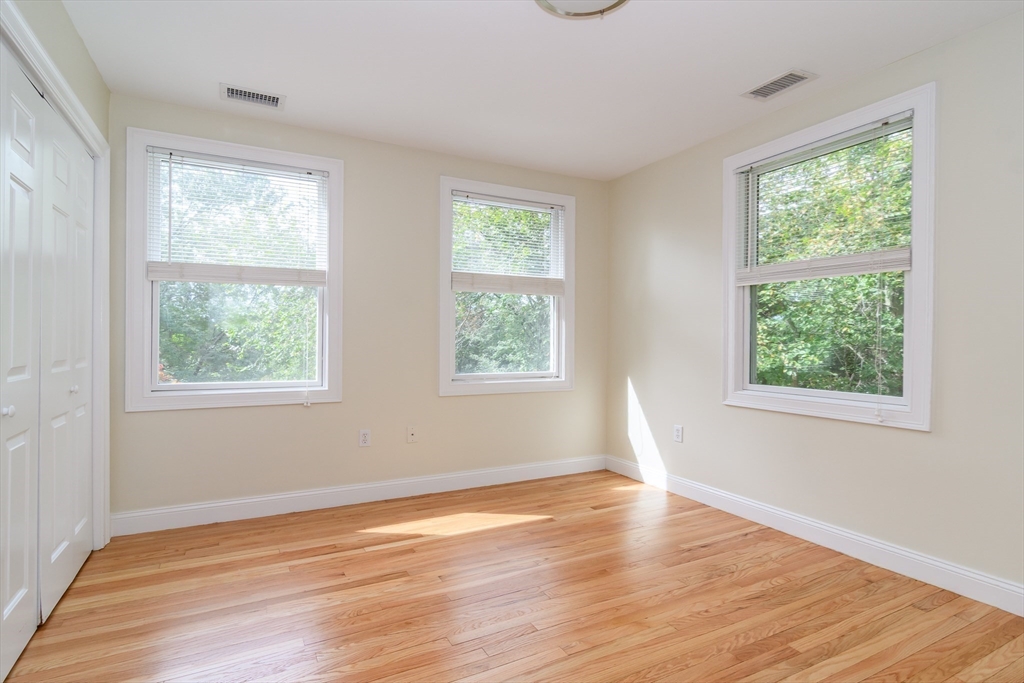 11 Parsons Way Natick, MA 01760 - Photo 18 of 29 a view of an empty room with wooden floor and a window
