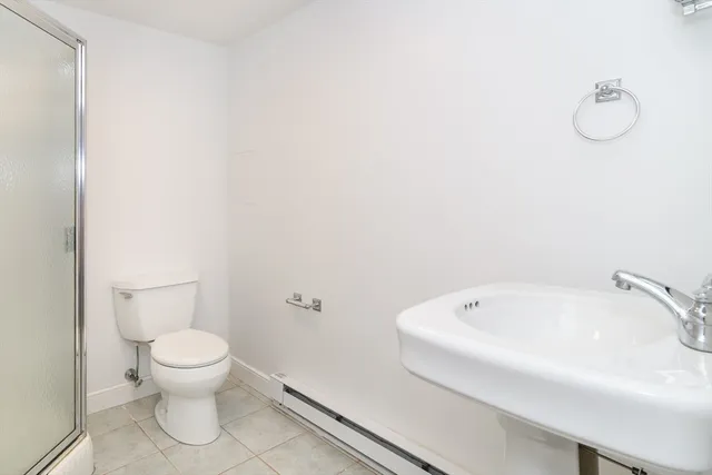 a bathroom with a white toilet and a tub