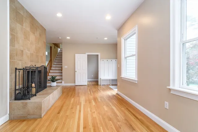 a view of empty room with wooden floor and windows
