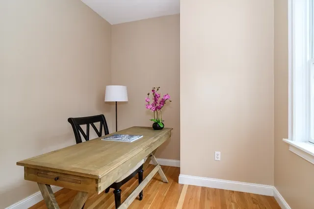 a dining room with furniture and wooden floor