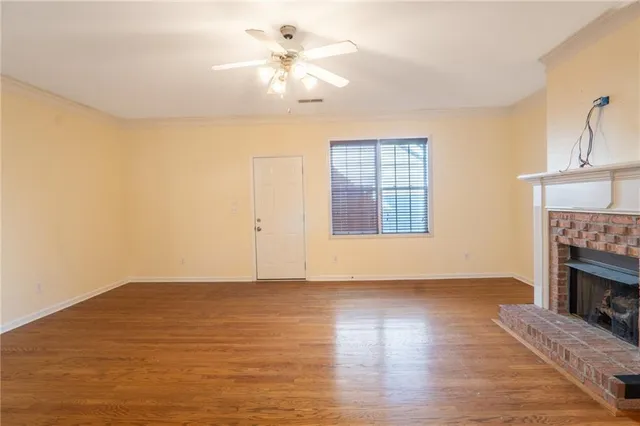 wooden floor in an empty room with a fireplace