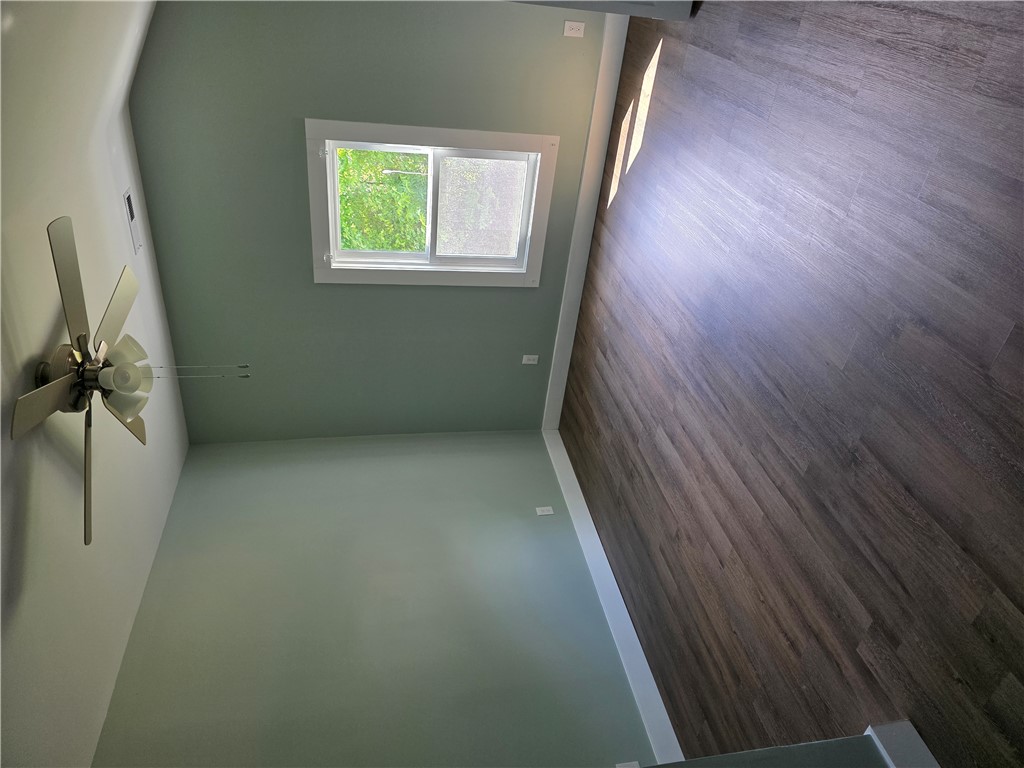 112 Simmons Street Anderson, SC 29625 - Photo 10 of 26 An inviting room features high ceilings and a durable wood floor, perfect for comfortable living.