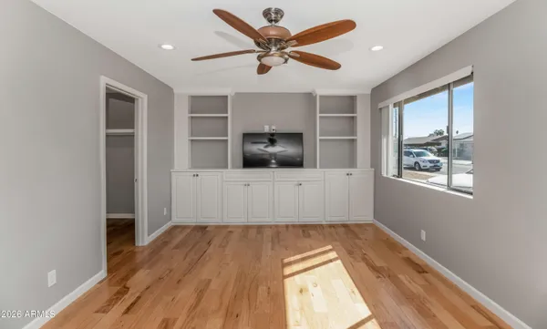 a living room with a flat screen tv and windows