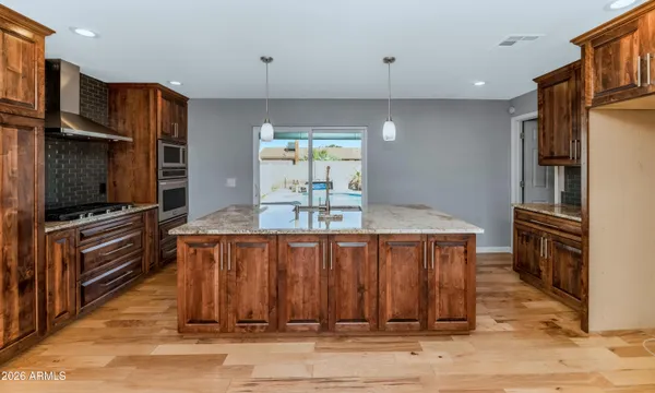 a kitchen with stainless steel appliances a refrigerator and a stove top oven