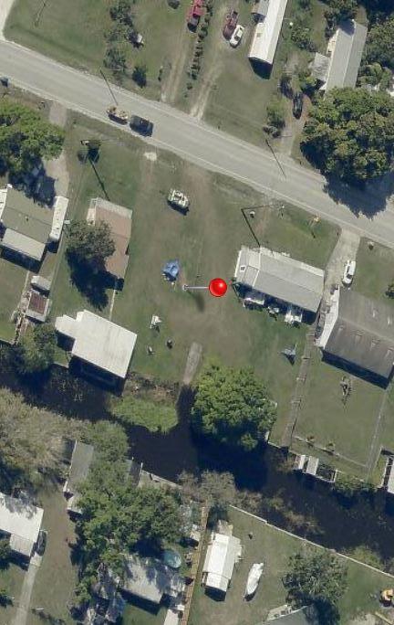 3232 Southeast 34th Avenue Okeechobee, FL 34974 - Photo 2 of 7 an aerial view of a house with a yard