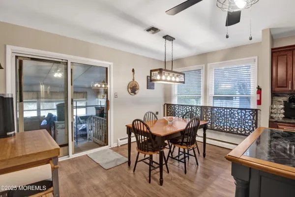 a view of a dining room with furniture wooden floor and chandelier