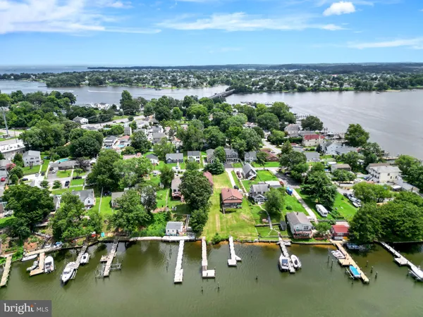 an aerial view of a city with lots of residential buildings lake and ocean view