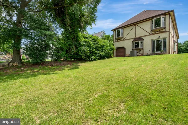 a view of a garden with a building in the background