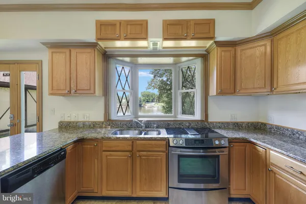 a kitchen with granite countertop cabinets and refrigerator