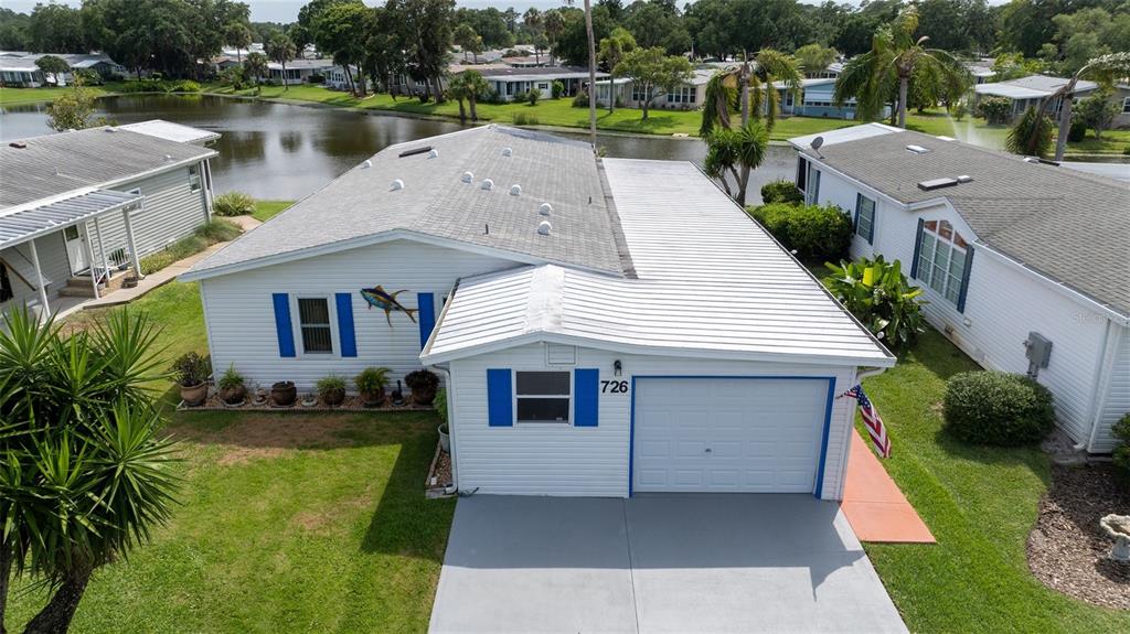 a aerial view of a house next to a lake view