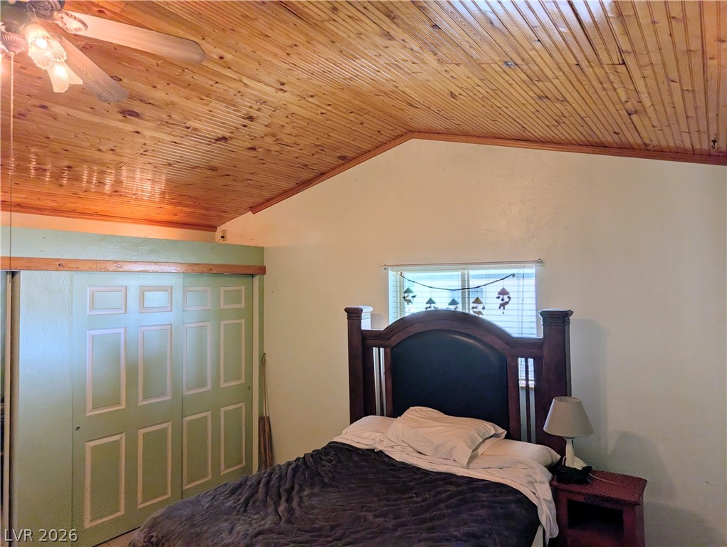 997 Phillips Street Panaca, NV 89042 - Photo 12 of 19 A well-appointed bedroom featuring a striking wood-paneled vaulted ceiling and a ceiling fan for comfort.