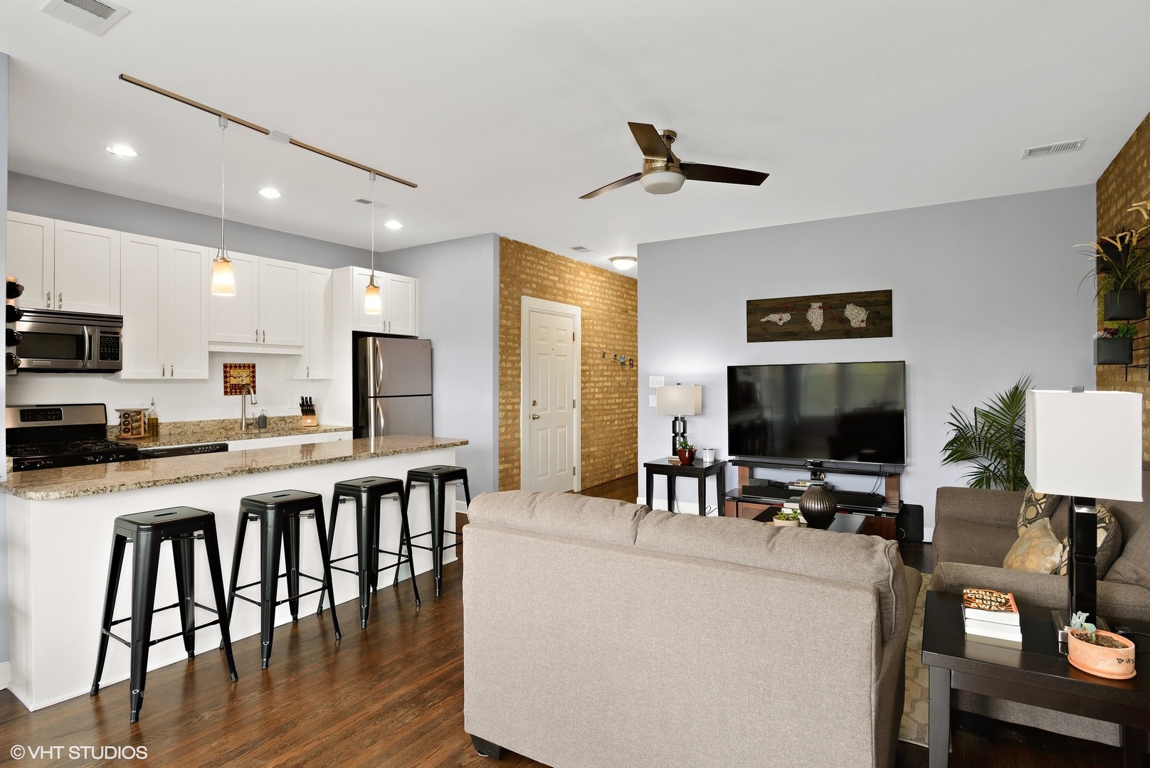2116 North Spaulding Avenue, Unit 21163 Chicago, IL 60647 - Photo 6 of 18 a view of kitchen with microwave stove refrigerator dining table and chairs