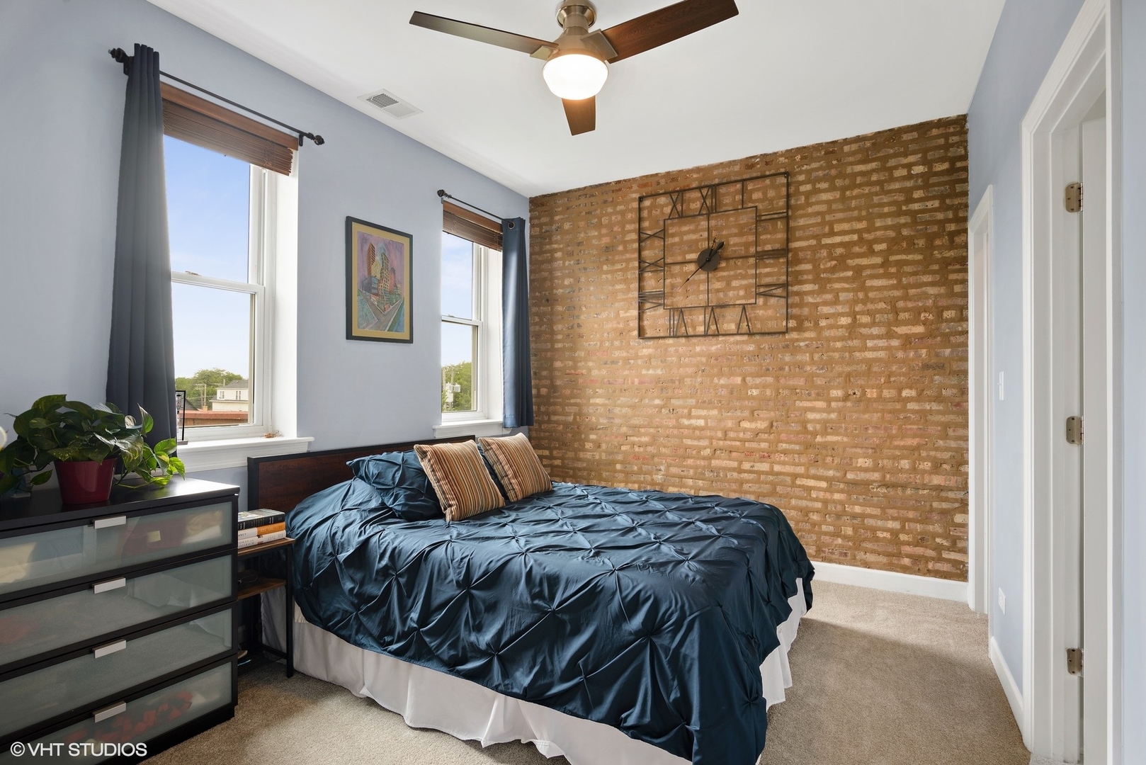2116 North Spaulding Avenue, Unit 21163 Chicago, IL 60647 - Photo 9 of 18 a bedroom with a bed and a potted plant