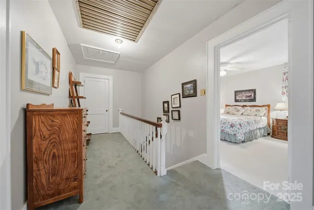 a view of a hallway with paintings on the wall