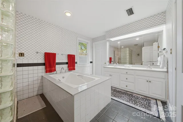 a bathroom with a sink vanity and mirror