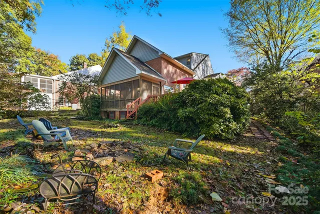a backyard of a house with table and chairs