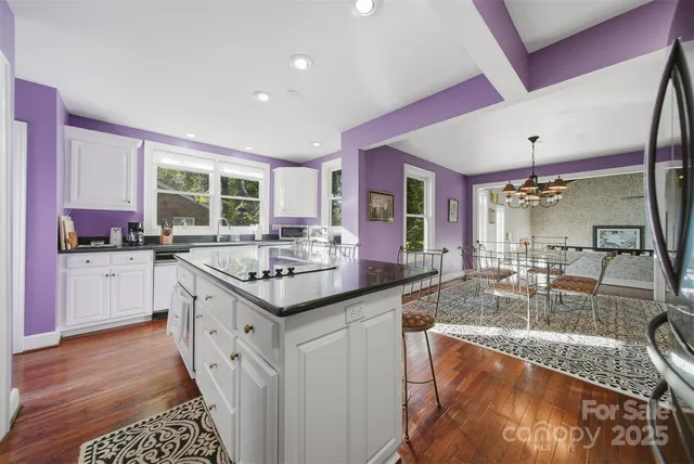 a kitchen with granite countertop a sink and cabinets