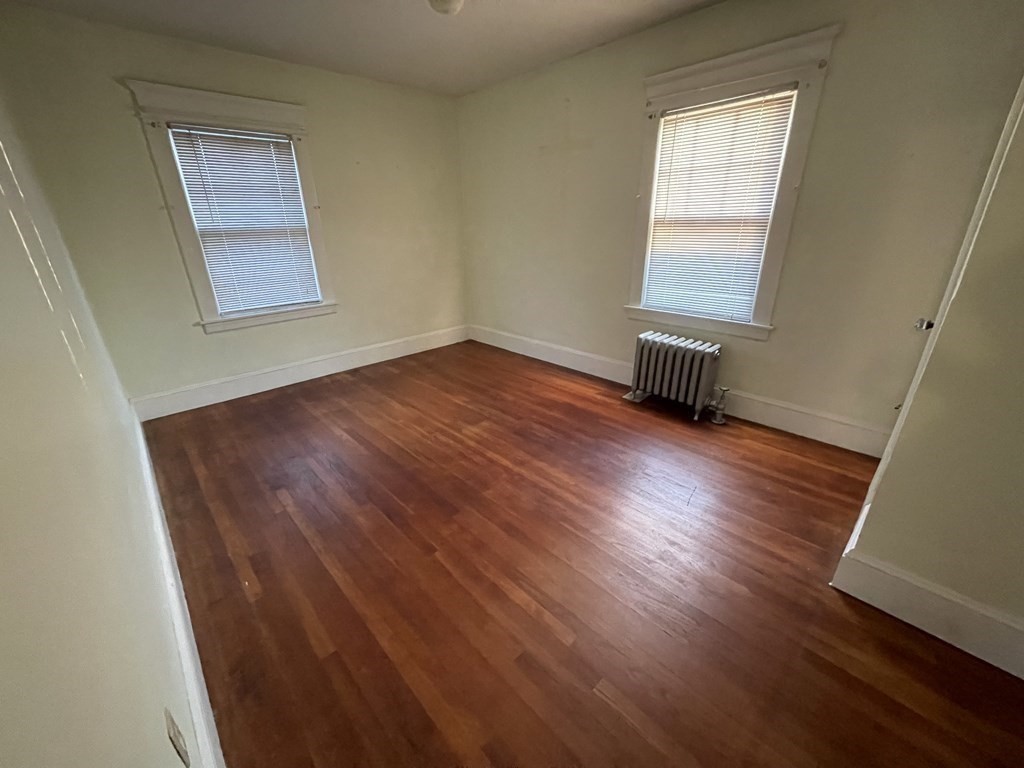 22 Thames Street Springfield, MA 01104 - Photo 11 of 15 an empty room with wooden floor and windows