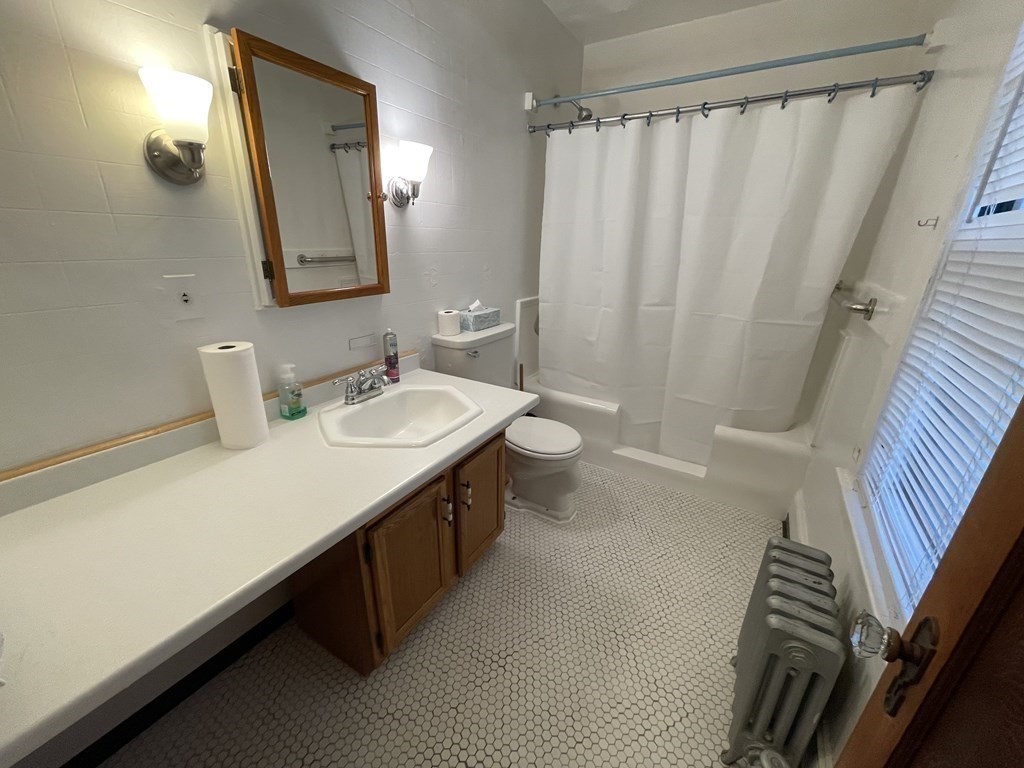 22 Thames Street Springfield, MA 01104 - Photo 9 of 15 a bathroom with a double vanity sink and a mirror