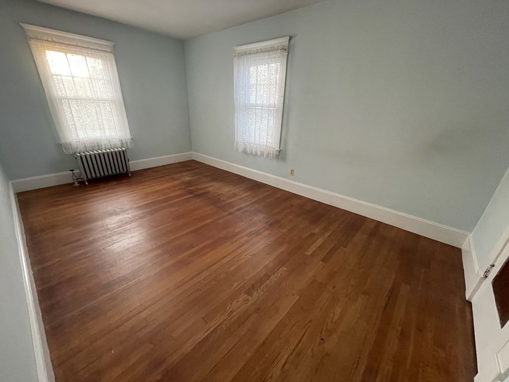 22 Thames Street Springfield, MA 01104 - Photo 10 of 15 an empty room with wooden floor and windows