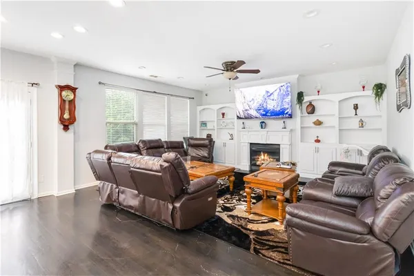 a living room with furniture a fireplace and a large window