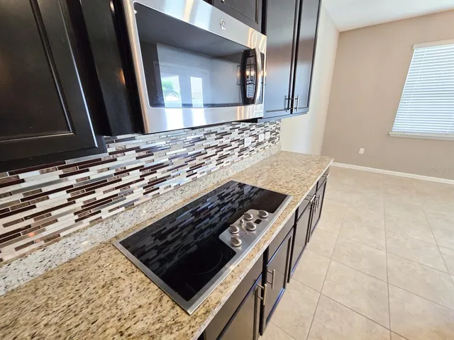 a stove top oven sitting inside of a kitchen