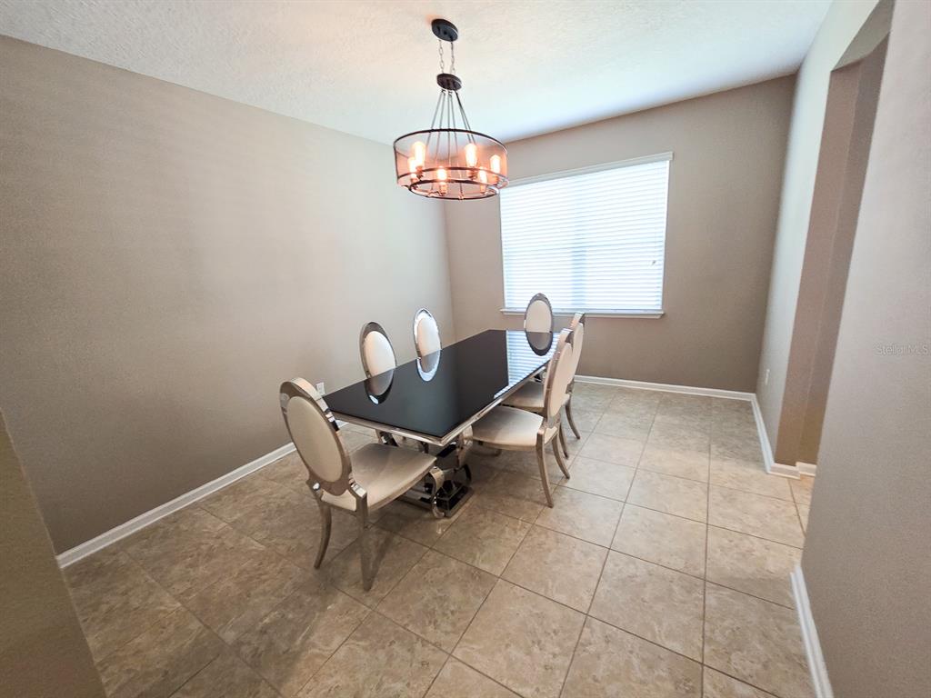 3543 Meadow Breeze Loop Ocoee, FL 34761 - Photo 15 of 38 a dining room with furniture and window